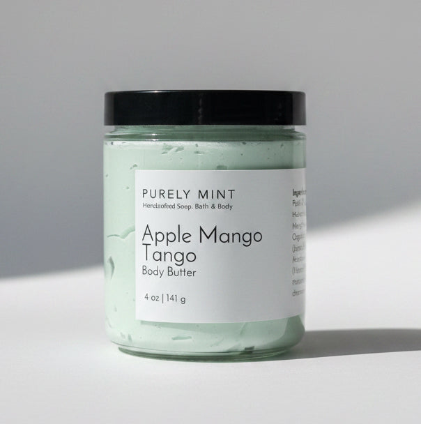 Apple Mango Tango body butter on a light gray backdrop.