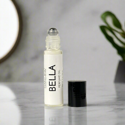 Perfume roller, white label, metal ball, black top, in a modern bathroom, counter, white, marble, luxury, spa, plants, commercial advertising photography.