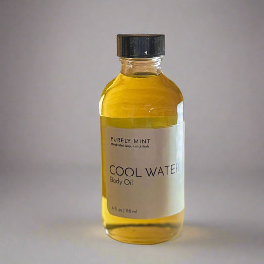4 oz Cool Water body oil in glass bottle, white label, black top in commercial photography packshot, light dark seamless backdrop, neutral lighting
