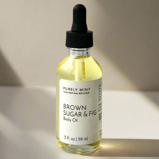 A sleek bottle of Purely Mint Brown Sugar & Fig body oil, featuring a minimalist label, set against a neutral background to highlight its natural aesthetic.
