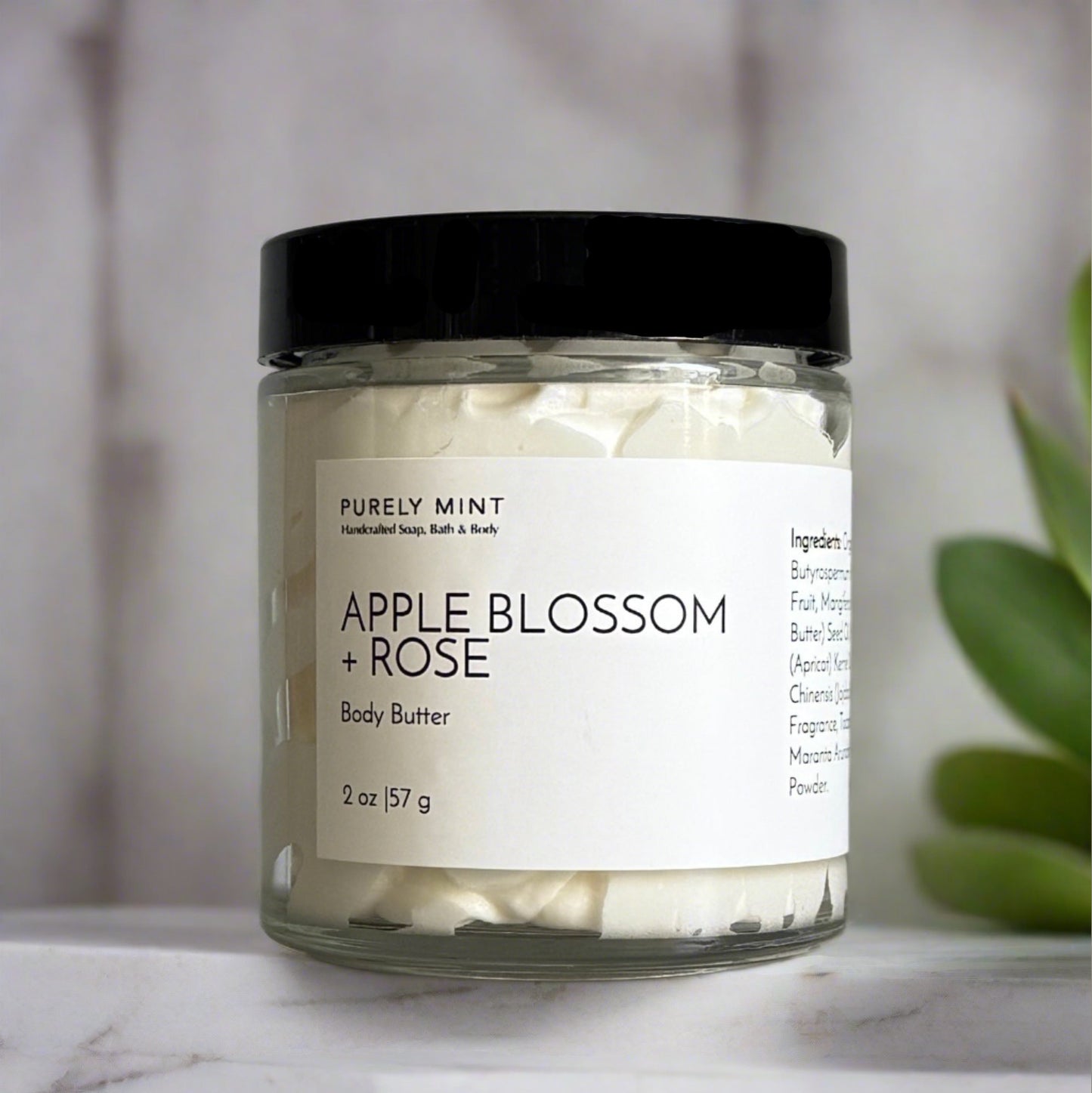small body butter with white label and black top in a modern bathroom, marble, luxury, spa, plants, commercial advertising photography