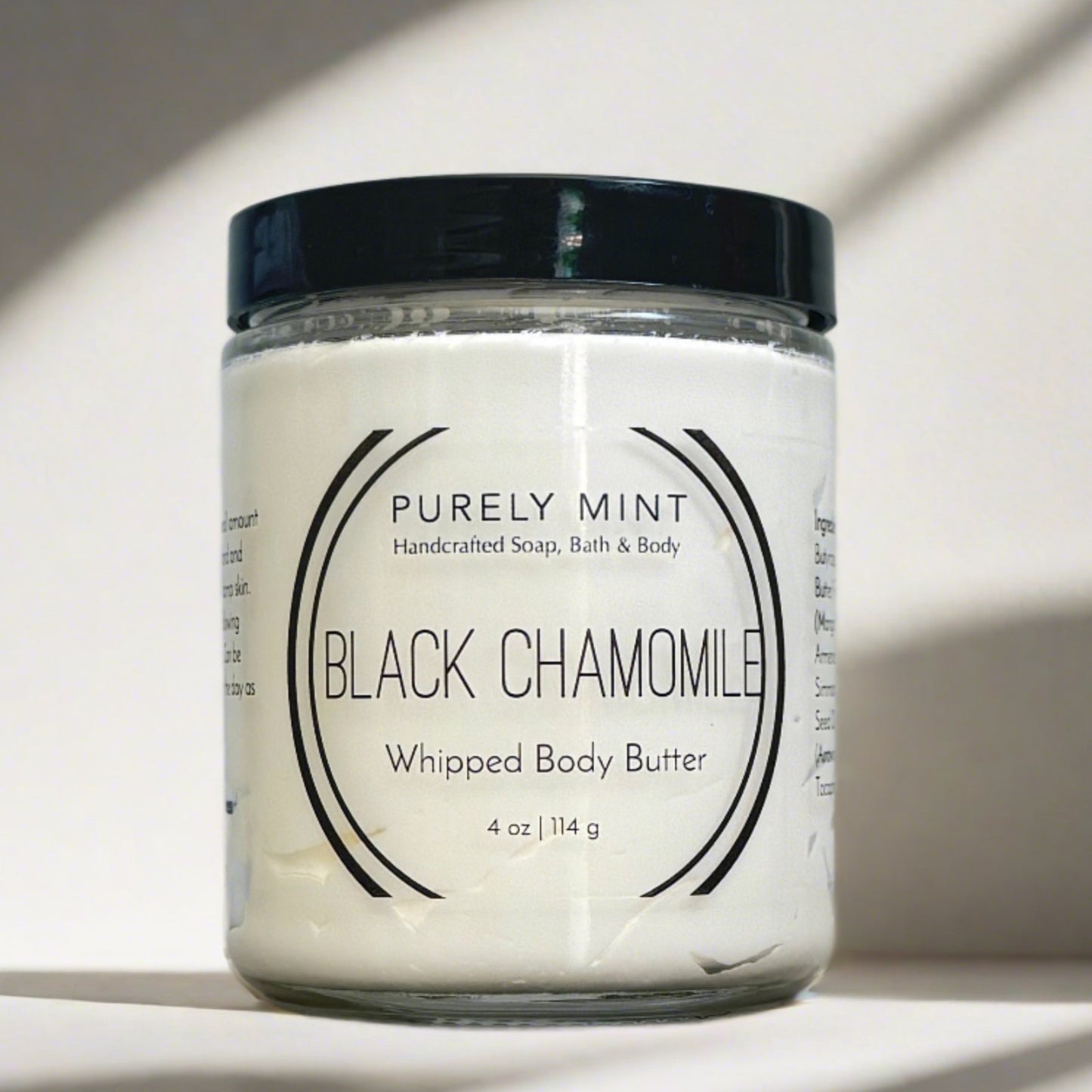 4 oz white body butter, glass jar, black lid, advertising style shot, soft sun shadow, empty penthouse, scandinavian minimalism, neutral warm, detailed