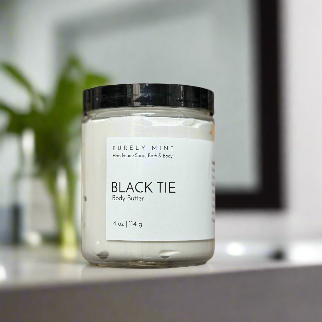 4 oz body butter, glass jar, white label, black top, in a modern bathroom, maple, luxury, manly, plants, commercial advertising photography