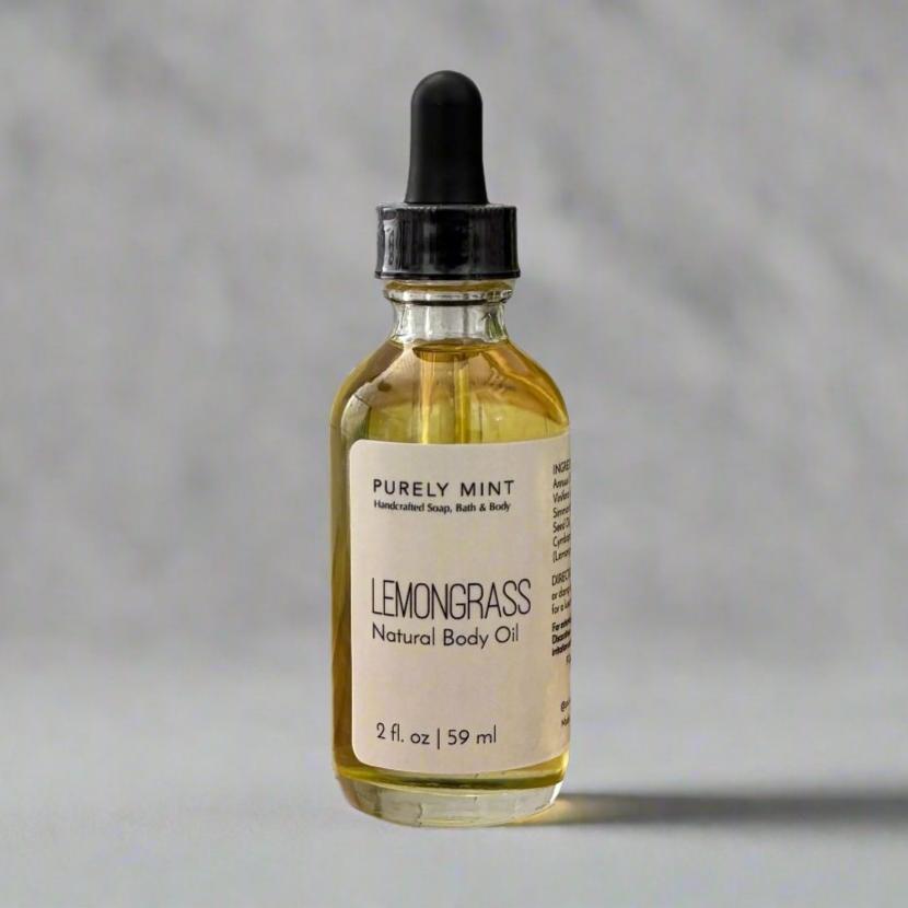 2 oz Lemongrass Natural Body Oil, in clear glass bottle with dropper top in a  commercial photography packshot, light gray seamless backdrop, neutral lighting