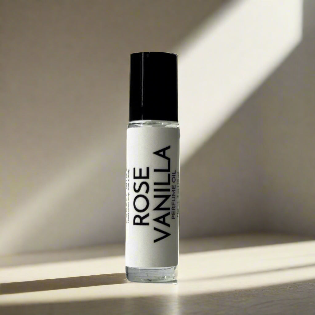 Roll-on perfume bottle labeled 'Rose Vanilla' on a light tan background