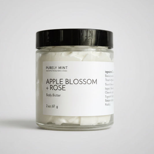 2 oz white body butter in glass jar, white label, black top, light gray seamless backdrop, neutral lighting