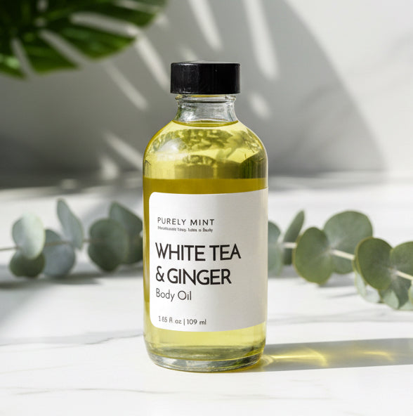 Bottle of White Tea & Ginger body oil in 4 oz on a marble surface with a gray background in a modern bathroom, marble, luxury, spa, plants, commercial advertising photography