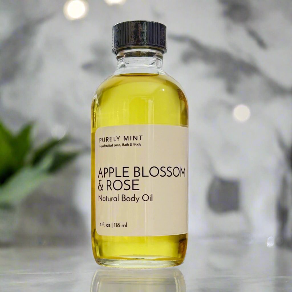 Apple Blossom & Rose Body Oil 4 oz, clear glass bottle, White label, black top, in a modern bathroom, marble, luxury, spa, plants, commercial advertising photography.