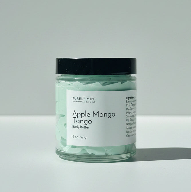 A jar of  Apple Mango Tango body butter on a light gray background.