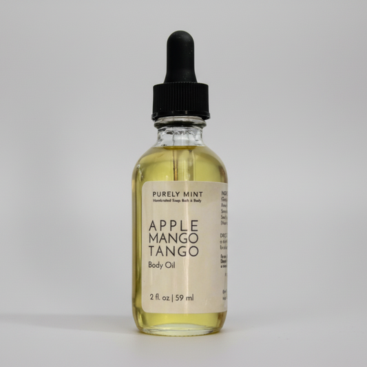 Bottle of Apple Mango Tango body oil from Purely Mint on a gray background