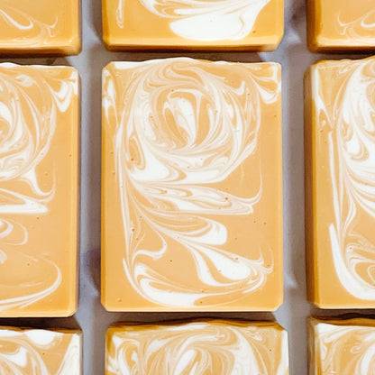 A grid of handmade banana coconut artisan soap bars with a marbled yellow and white pattern, arranged to form a larger image.