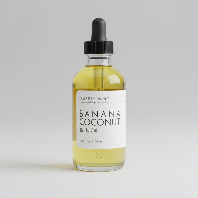 Bottle of banana coconut oil on a gray backdrop.