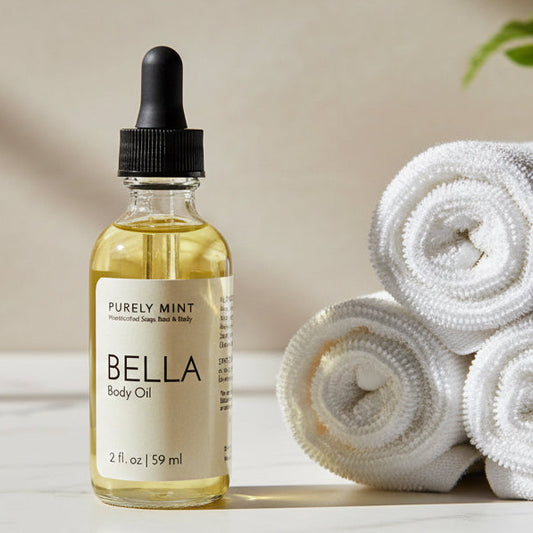 2 oz body oil, glass bottle, dropper top,  marble counter, white rolled washcloths, green plant.