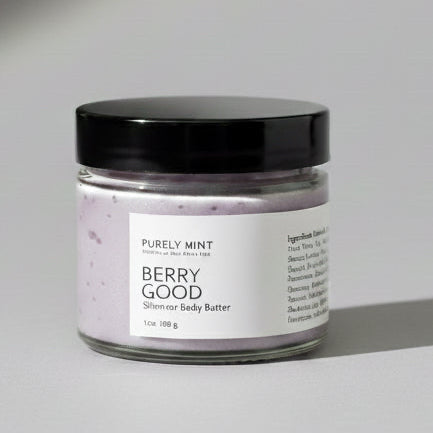 Small jar of Berry Good body butter on a light gray seamless backdrop