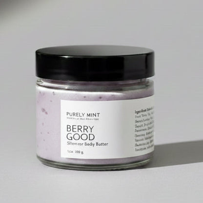 Small jar of Berry Good body butter on a light gray seamless backdrop