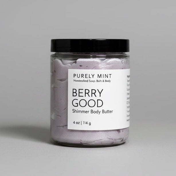 Jar of berry good body butter with a label on a light gray background