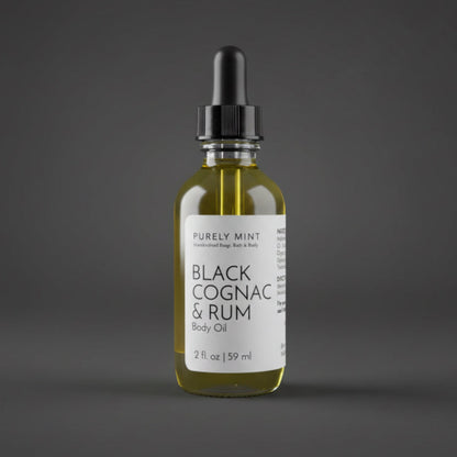 A 2 oz bottle of Black Cognac & Rum Body Oil with a white label and black dropper.