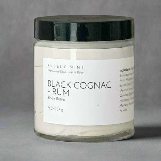 2 oz white body butter, white label, black top, commercial photography packshot, charcoal seamless backdrop, neutral lighting