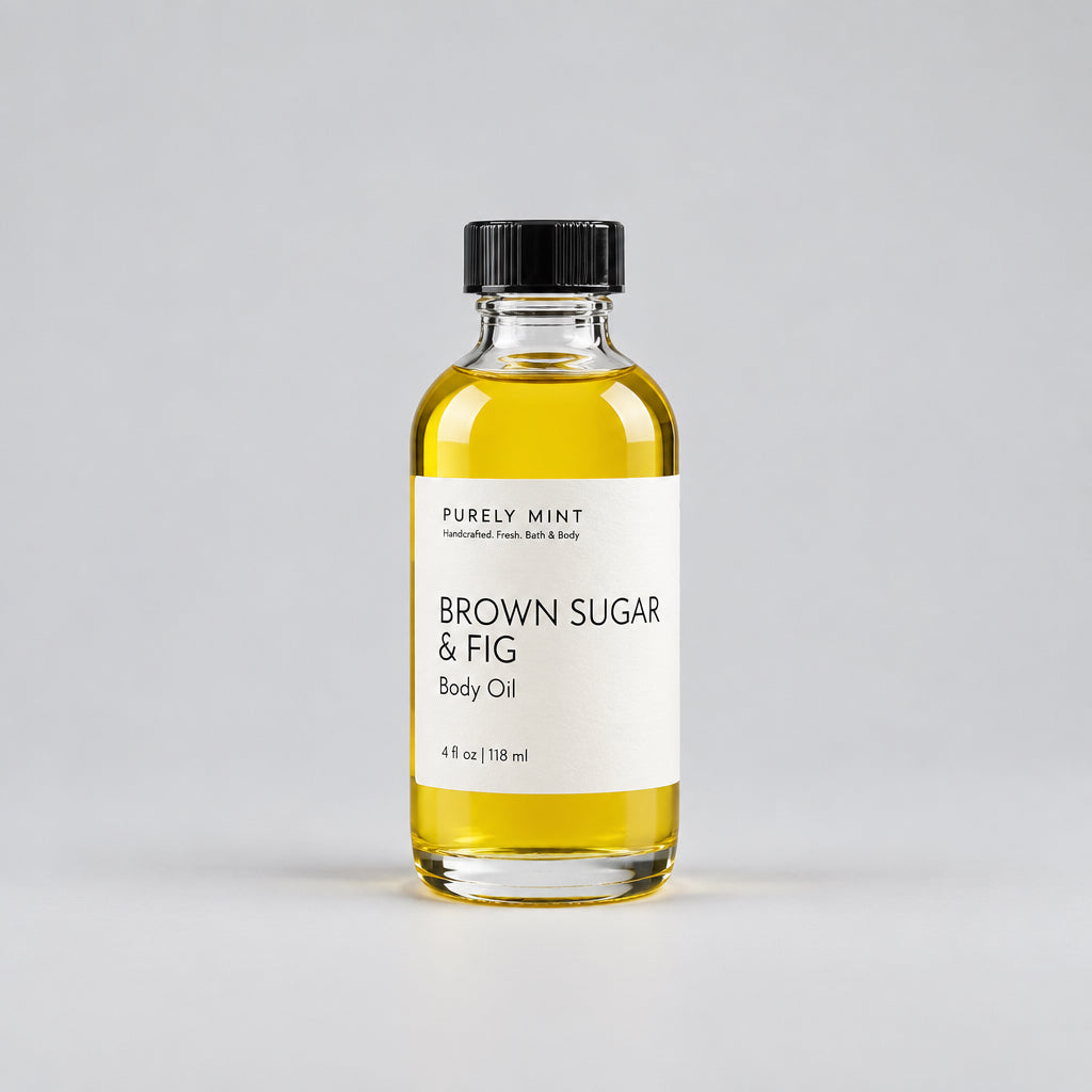 A clear glass bottle of Purely Mint Brown Sugar & Fig Body Oil with a black cap and white label, set against a clean light gray background.