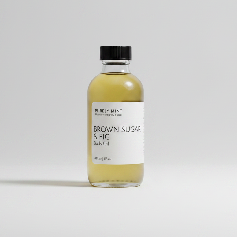 A clear glass bottle of Purely Mint Brown Sugar & Fig Body Oil with a black cap and white label, set against a clean light gray background.