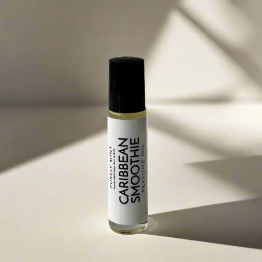 Roll-on bottle of 'Caribbean Smoothie' perfume oil on a light tan background