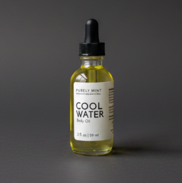 A bottle of Purely Mint Cool Water Body Oil with pale yellow oil inside, a white label, and a black dropper top, set against a dark gray backdrop.