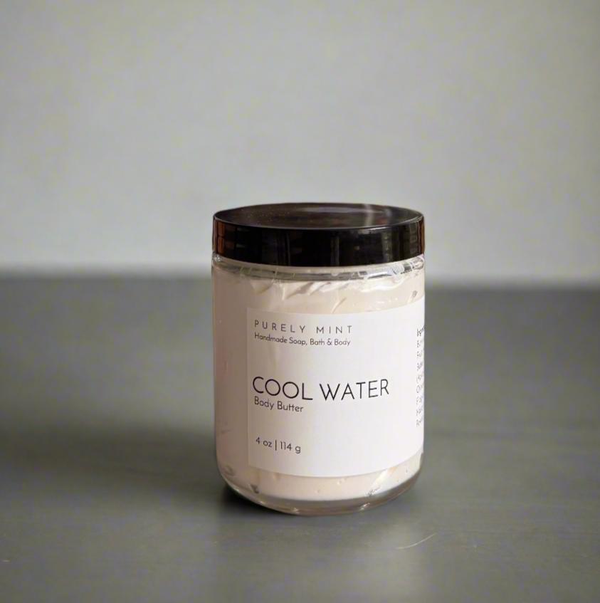 4 oz white body butter, white label, black top, bathroom counter, dark, manly