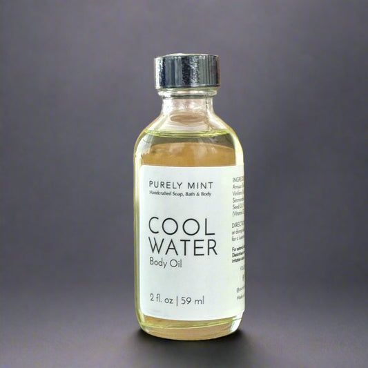 2 oz Cool Water body oil, clear glass bottle, white lable, black dropper top, commercial photography packshot, dark gray seamless backdrop.