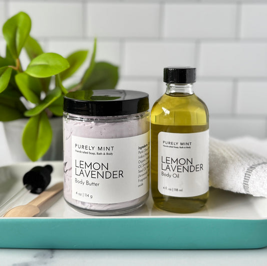 Purely Mint Lemon Lavender Body butter and body oil on a tray with a plant in the background.