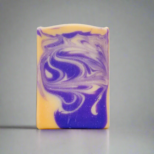 Purple and yellow soap in commercial photography packshot, light gray seamless backdrop, neutral lighting