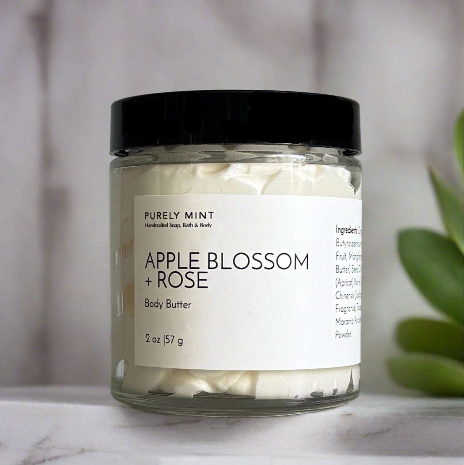 small body butter with white label and black top in a modern bathroom, marble, luxury, spa, plants, commercial advertising photography