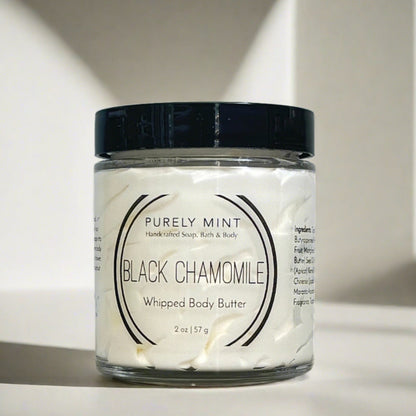 small white body butter in glass jar with black lid in a modern bathroom, marble, luxury, spa, plants, commercial advertising photography