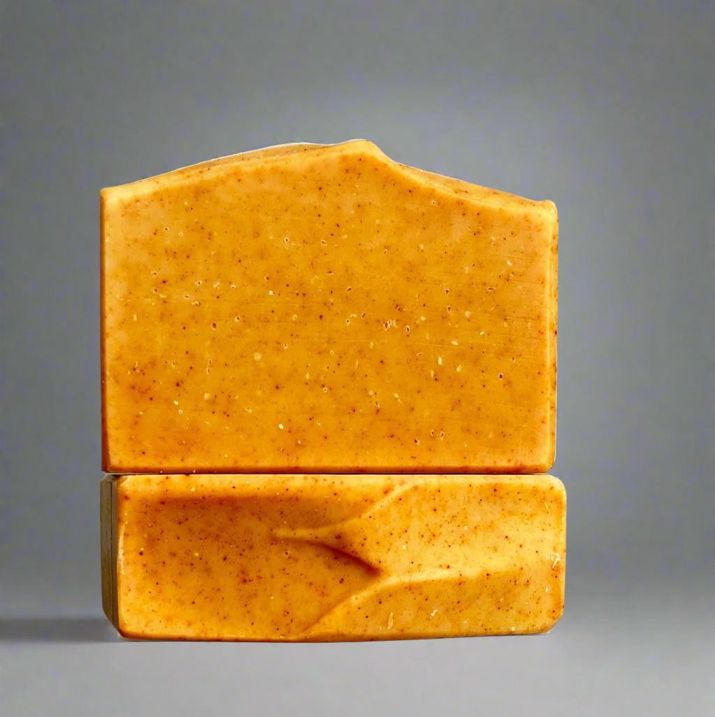 2 orange turmeric soaps, commercial photography packshot, light gray seamless backdrop, neutral lighting