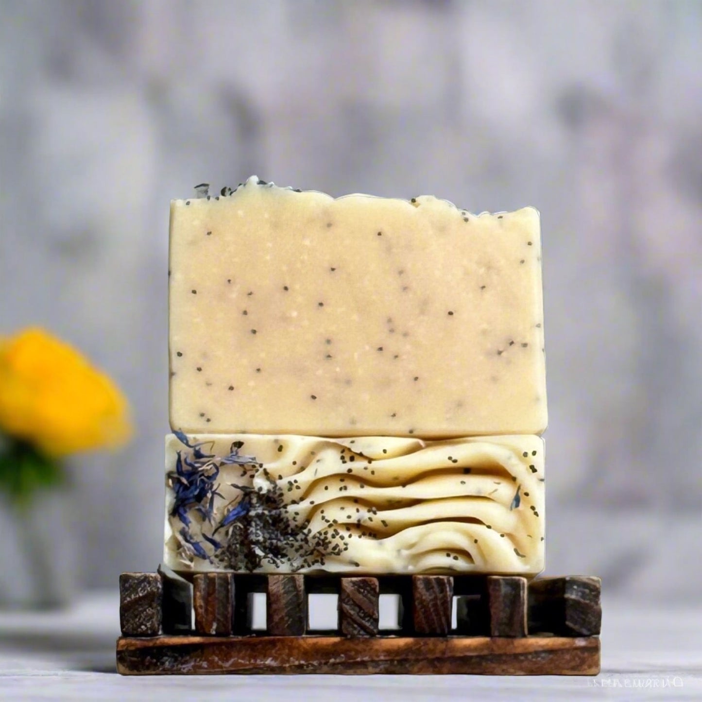 yellow soap with specks of black poppy seeds in a modern bathroom, marble, luxury, spa, plants, commercial advertising photography