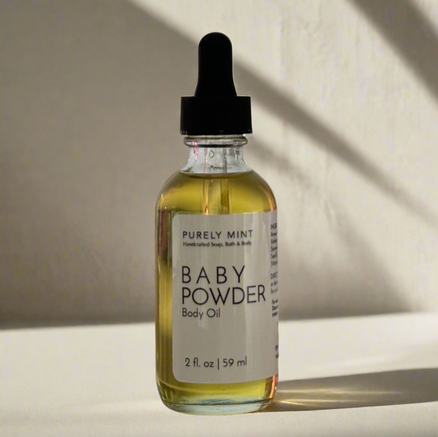 2 oz body oil in a glass bottle with white lable and black dropper top. Advertising style shot, soft sun shadow, empty penthouse, scandinavian minimalism, neutral warm, detailed