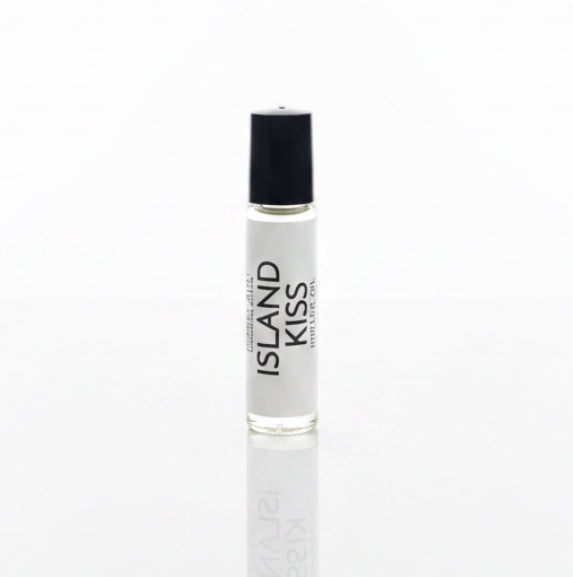 Island Kiss Perfume Oil on a white reflective backdrop. 