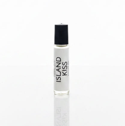 Island Kiss Perfume Oil on a white reflective backdrop. 