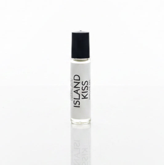 Island Kiss Perfume Oil on a white reflective backdrop. 