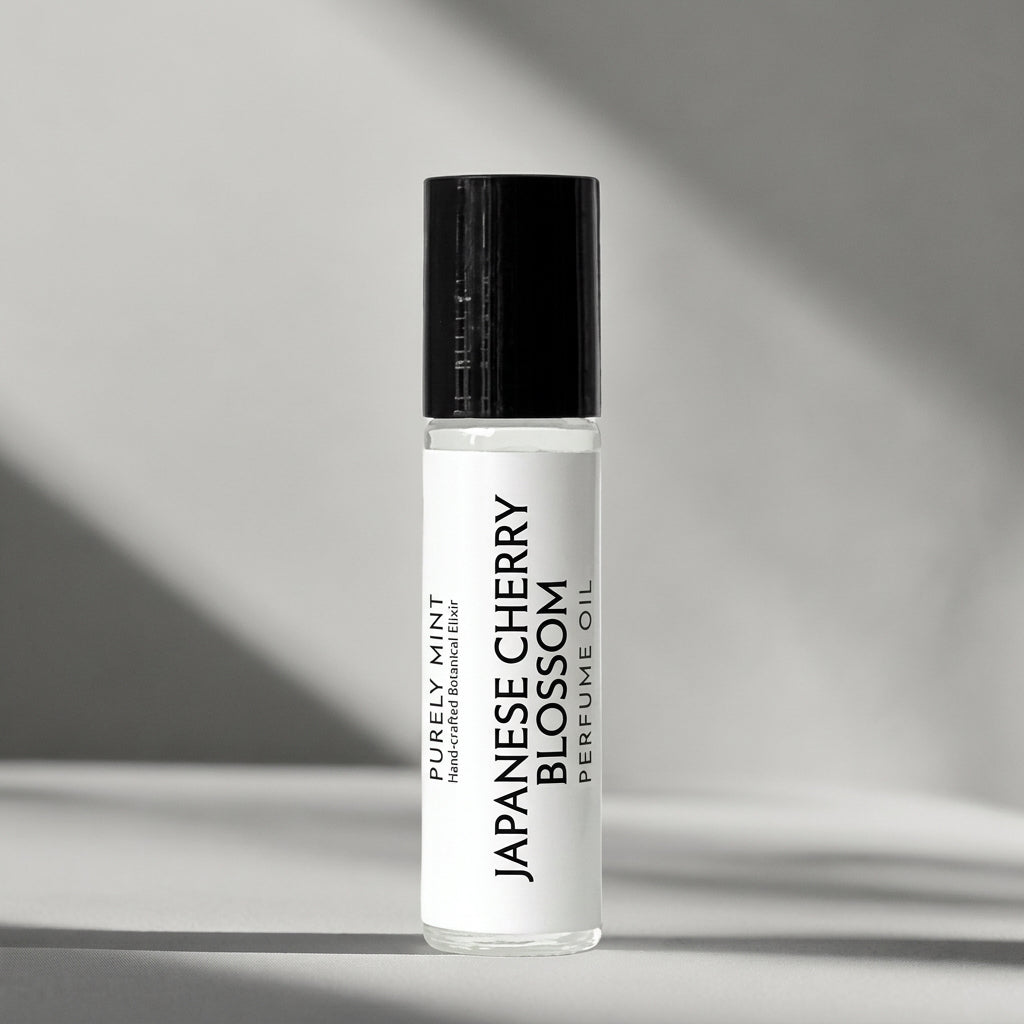 Japanese Cherry Blossom perfume oil with a white label and black cap, displayed on a light background.