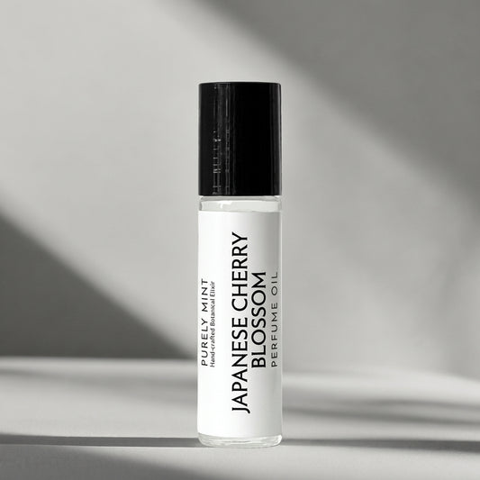 Japanese Cherry Blossom perfume oil with a white label and black cap, displayed on a light background.