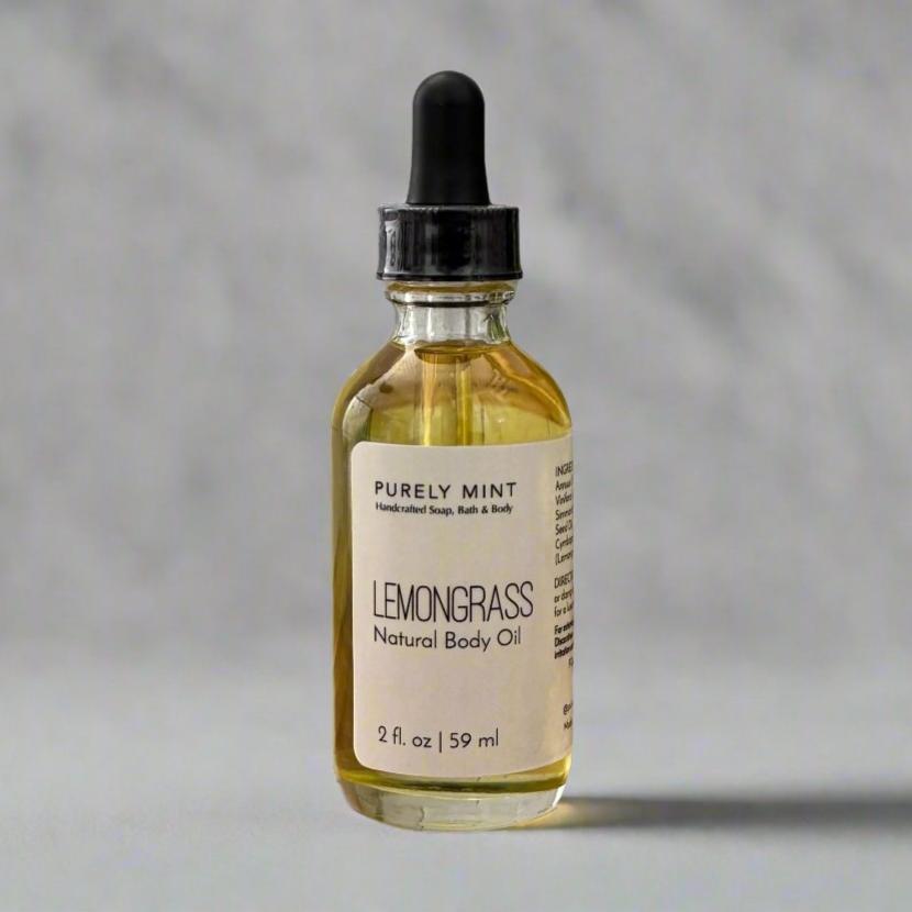  2 oz Lemongrass Natural Body Oil, in clear glass bottle with dropper top in a  commercial photography packshot, light gray seamless backdrop, neutral lighting