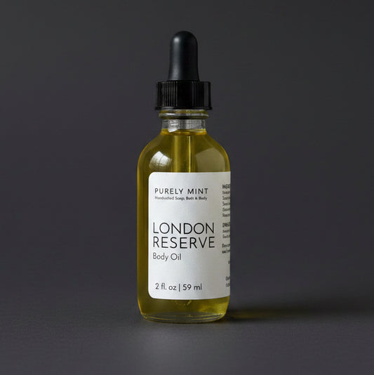 Bottle of London Reserve body oil with a dropper on a dark gray background