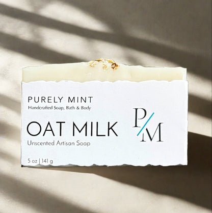 Oat Milk Unscented Soap wrapped in a white label on a neutral background