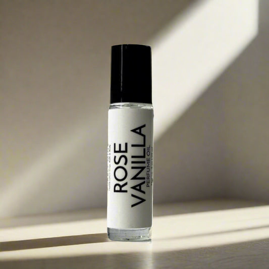 Roll-on perfume bottle labeled 'Rose Vanilla' on a light tan background