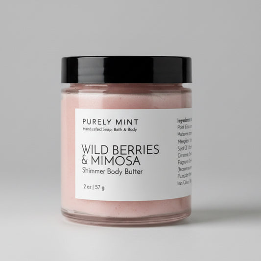 Jar of  Wild Berries & Mimosa body butter with a label on a light grey backdrop.