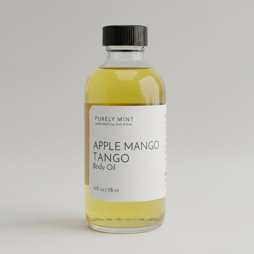 Bottle of apple mango tango Body oil on a light gray seamless backdrop, neutral lighting.