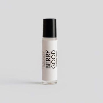 Womens Perfume Oil Roll On. This clear glass roll-on bottle comes with a sleek black cap. It’s labeled ‘PURELY MINT Hand-Crafted Soaps, Bath & Body BERRY GOOD Perfume Oil’.