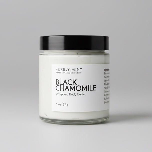 Bottle of Black Chamomile body butter on a light gray seamless backdrop.