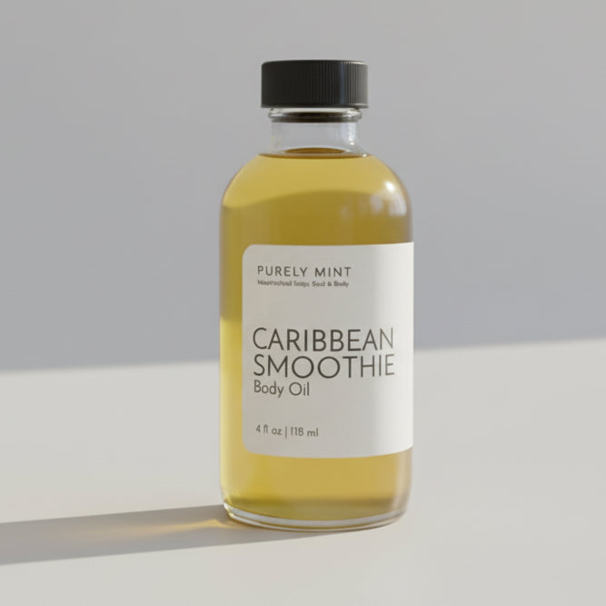 Bottle of Caribbean Smoothie body oil with a white label with a black top, on  light gray seamless backdrop.