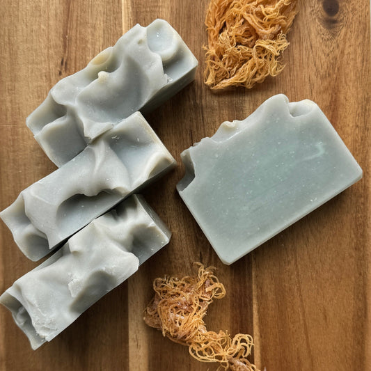 4 blue sea moss soaps on wood background, sea moss pictured.